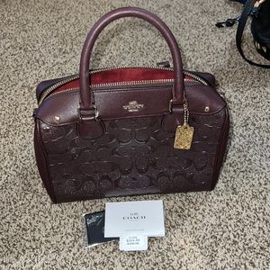 Coach purple top handle purse.